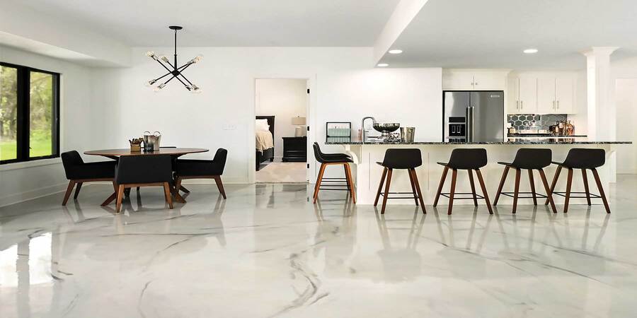 This image shows a living room and a dining room that has an epoxy floor.